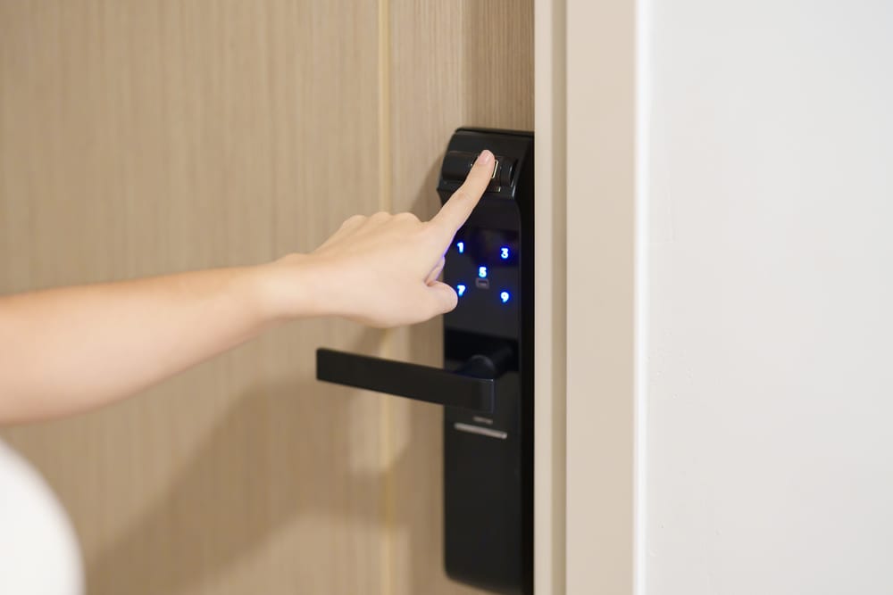 Person using digital keypad door lock.