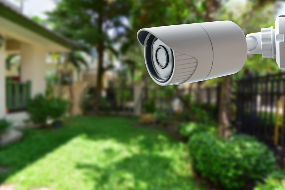 Outdoor security camera monitoring residential backyard.
